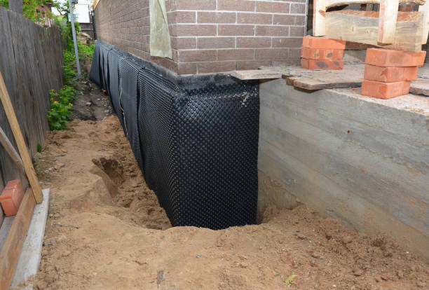 SJ Waterproofing Pros technician performing targeted Wet Basement Repair assessment in Amboy, IN
